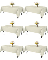 Niuara Ivory 60x84 rectangle tablecloth drapes elegantly on a 5ft table.