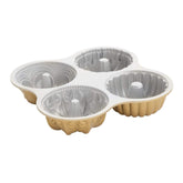 Nordic Ware Bundt Quartet Pan in gold, swirl design for stunning cakes.