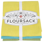 Now Designs flour sack towel with chartreuse, turquoise, and leaf pattern on counter, ideal for drying glassware