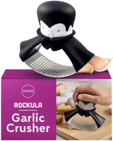 OTOTO Rockula garlic press on a cutting board for quick mincing.