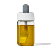 OXO Good Grips glass oil bottle shows precise dispensing for cookware