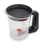 OXO Good Grips Good Gravy 4-Cup Fat Separator pouring liquid with fat separation