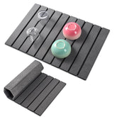 Oxydrily foldable stone drying mat folded for compact storage and easy countertop cleanup.