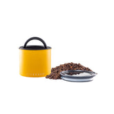 Planetary Design Airscape canister close-up showing matte yellow lid and steel body preserving freshness.