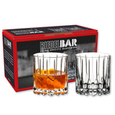 Riedel neat glass in hand, ergonomic grip for precise pours.