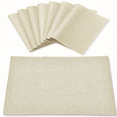 Rinpon beige cloth placemats with linen-look finish protect the table from heat and spills.