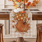 Romanstile pumpkin leaves fall table runner on a warm autumn dining table.