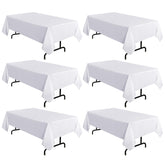 Sancua six-pack white tablecloths 60x120 on a dining table, clean and polished.