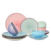 Selamica 12-piece dinnerware on tabletop with hand-painted swirl and spray dots.