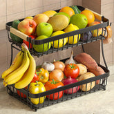 Sevenblue 2-tier fruit basket with banana hangers keeps fruit organized on the counter.