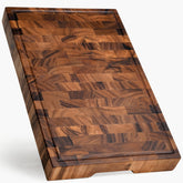 SHUMARU tropical walnut end-grain board with juice groove for mess-free prep.