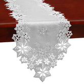 Simhomsen embroidered silver snowflakes table runner closeup showing crisp stitching for festive decor.