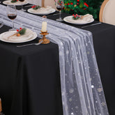 Snowkingdom snowflake table runner draped over a table for festive dining.