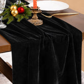Socomi black velvet table runner on a dining table adds luxurious elegance.