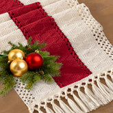 Socomi boho table runner with macrame in red ivory enhances rustic dining ambiance.