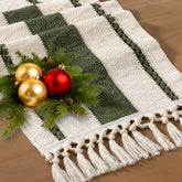 Socomi boho table runner in olive green with macrame fringe for rustic dining ambiance.
