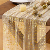 Socomi Christmas Snow Table Runner in gold gauze adds festive shine to holiday table settings.
