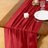 Socomi red cheesecloth table runner on wedding arch for rustic charm