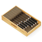 SpaceAid knife drawer organizer in bamboo keeps knives neatly aligned for easy access.