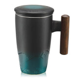 Suyika ceramic tea cup with infuser and lid, ergonomic wooden handle.