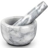 Tera mortar and pestle with small white bowl for fresh spice grinding.