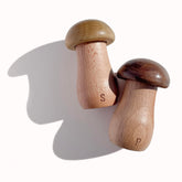 The Loquat Tree mushroom salt shaker on a rustic table for farmhouse charm.