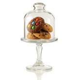 The Mask El Turko mini glass cake stand with dome cover showcasing desserts while keeping them fresh.