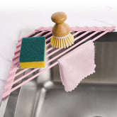 Tomorotec pink triangle dish rack in a corner sink saves counter space while drying dishes.