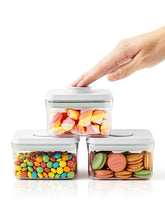 Tourdeus pop container with button lid for quick, one-handed snack access.