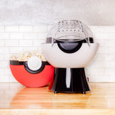Uncanny Brands Poké Ball popcorn maker pops oil-free popcorn quickly.