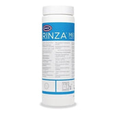Urnex Rinza tablet dissolving in water to clean milk system components