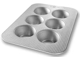 USA Pan jumbo Texas muffin pan top view highlights durable aluminized steel for even baking.