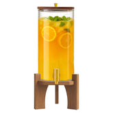 Verssure glass dispenser on round wooden stand enhances centerpiece appeal.