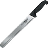 Victorинox Fibrox 12-inch slicing knife with Granton edge close-up highlighting the blade's texture and grip.