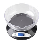 Weighmax 2810-2KG black digital scale with tare function on a kitchen counter.