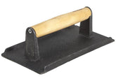 Winco cast iron steak weight, top view, aids even heat contact.