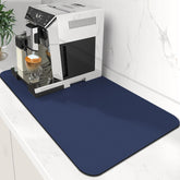 WISELIFE Coffee Mat under the coffee maker captures spills and protects the counter.