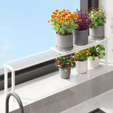 WOCHUANGSI expandable window shelf displays plants on a sunlit sill for space-saving display.