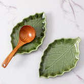 YumiPLUS ceramic leaf spoon rest on stove top, keeps counters tidy and utensils handy.