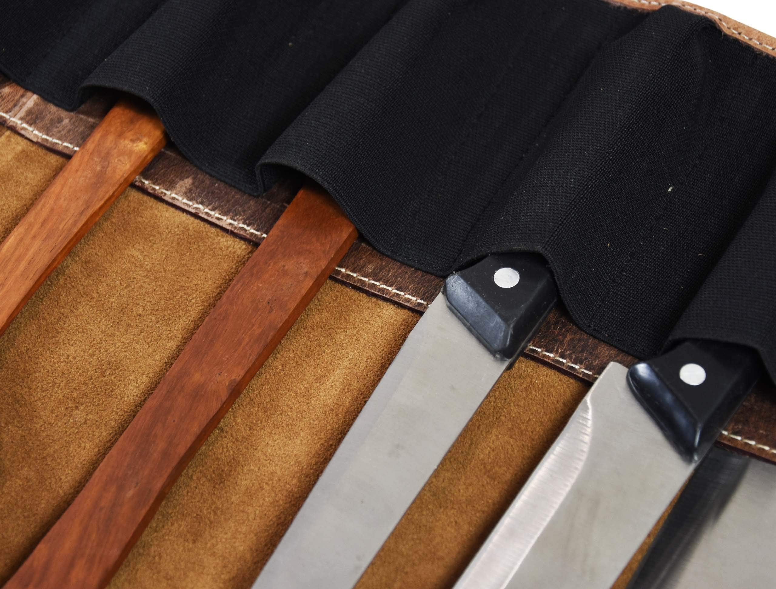 Aaron Leather Knife Roll holds ten kitchen knives securely during travel.