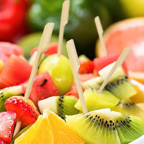 Acshio kebabs, sandwiches, and fruit skewers ready for serving.