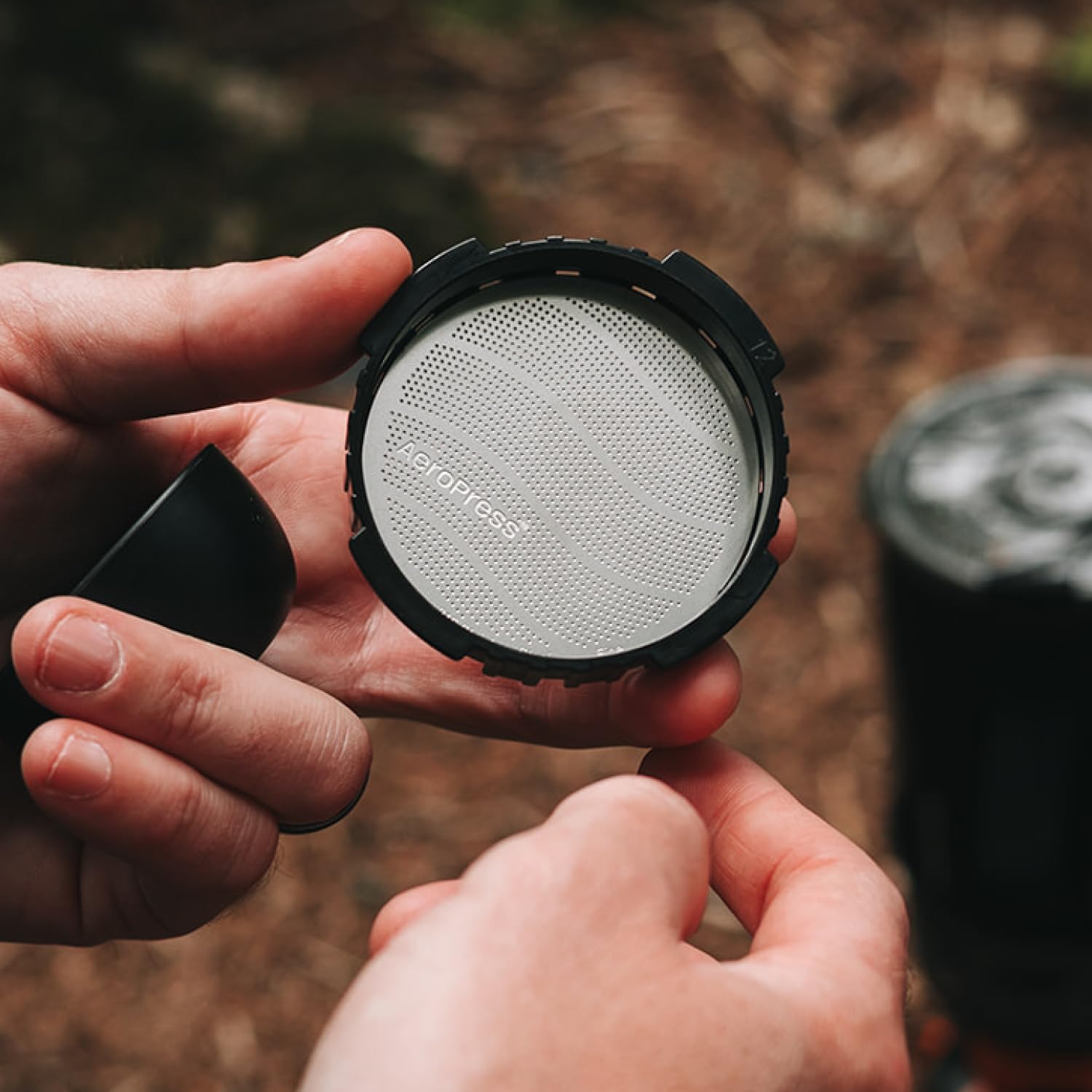 AeroPress reusable filter during brew process emphasizing fine filtration.
