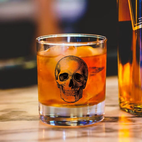 AGMDESIGN Skeleton Skull Whiskey Glass embossed detail catches light for striking barware.