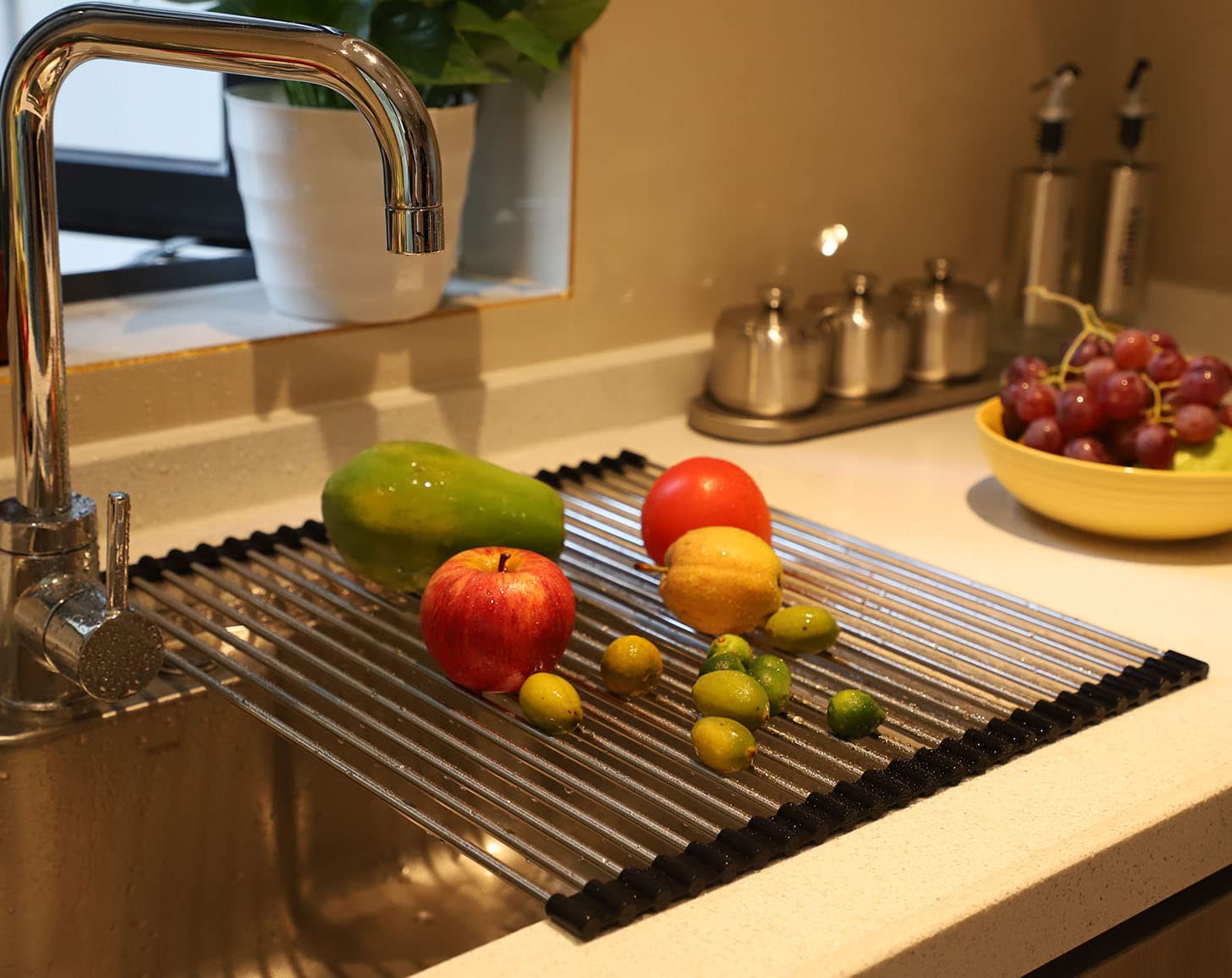 Ahyuan roll-up dish drying rack with stainless steel pipes and end grips for sturdy support.
