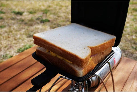 AILITOR campfire sandwich setup enables toasted meals outdoors.