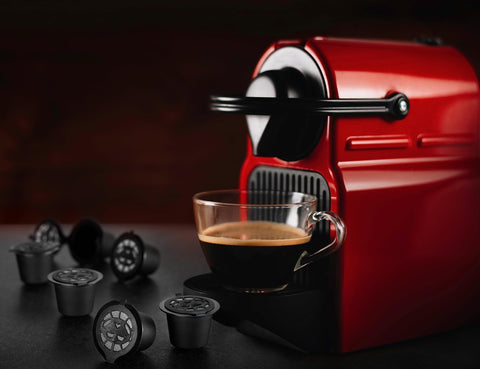 Close-up of espresso pouring from Alchemy Bar Goods refillable pod.
