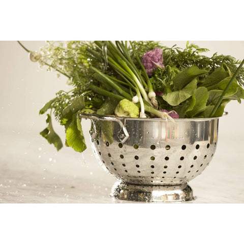 All-Clad colander with rolled edges reducing drips during pouring