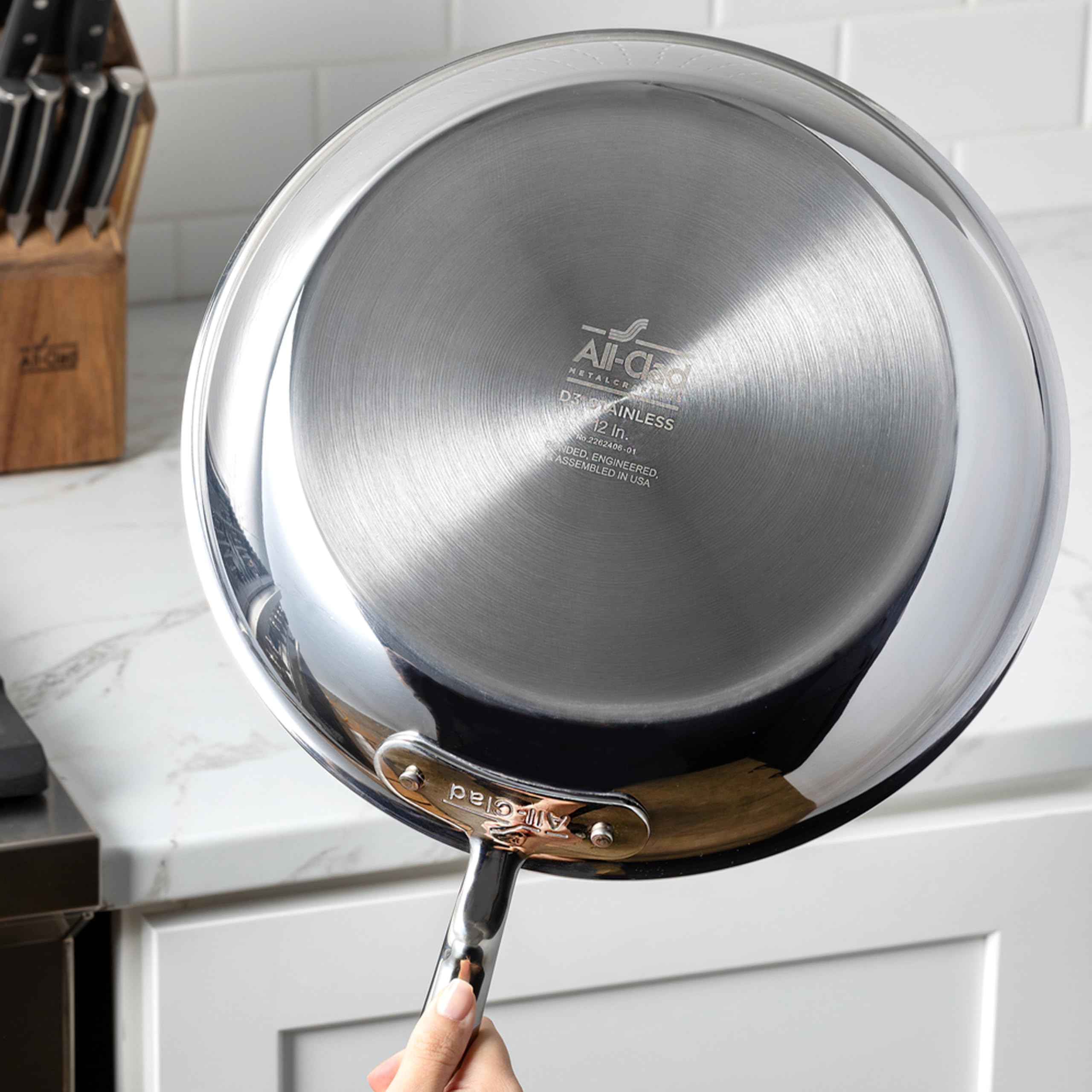 All-Clad D3 2-qt with lid captures steam for simmered sauces.