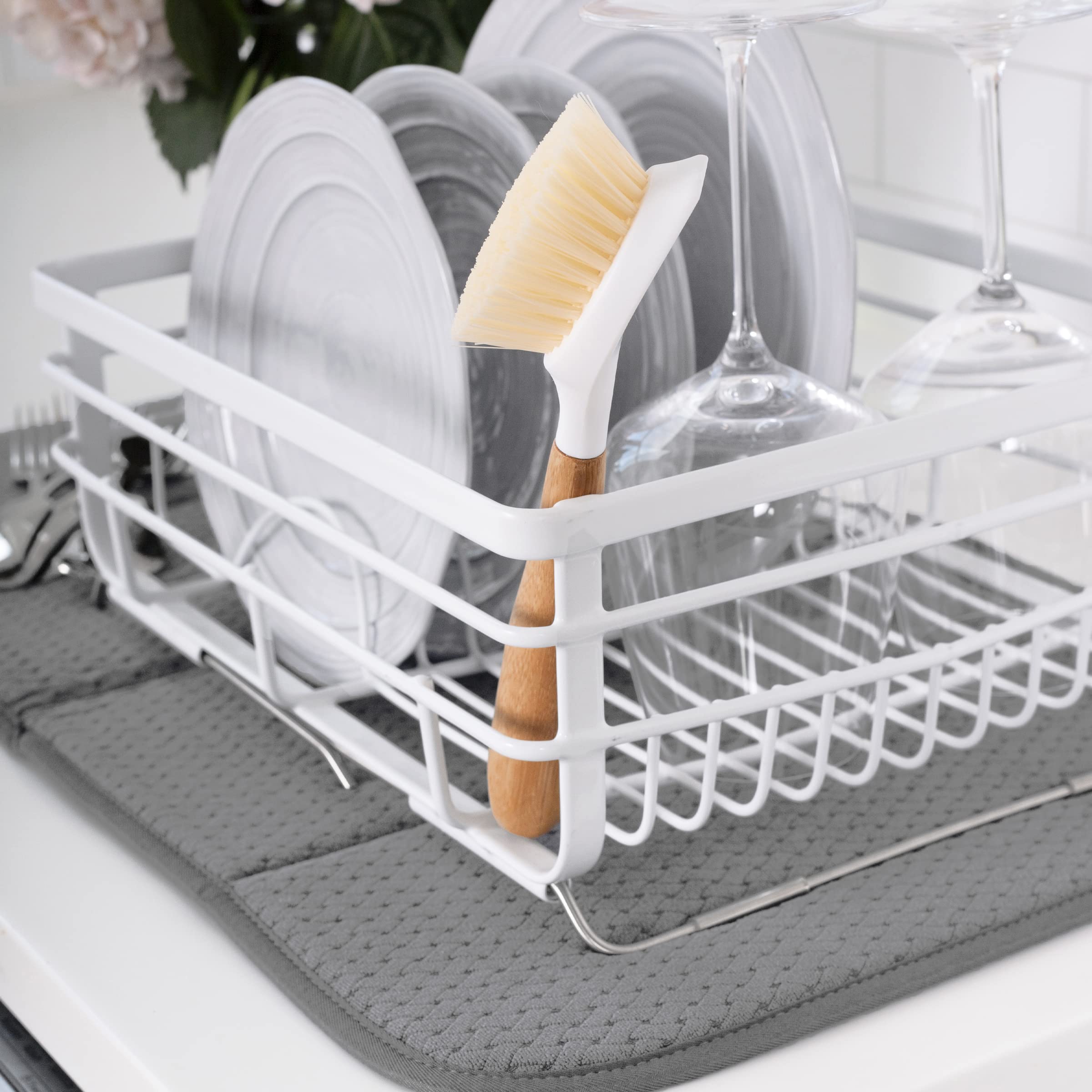 All-Clad dish drying mat folded for compact storage on a kitchen counter.