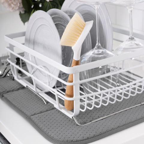 All-Clad dish drying mat folded for compact storage on a kitchen counter.